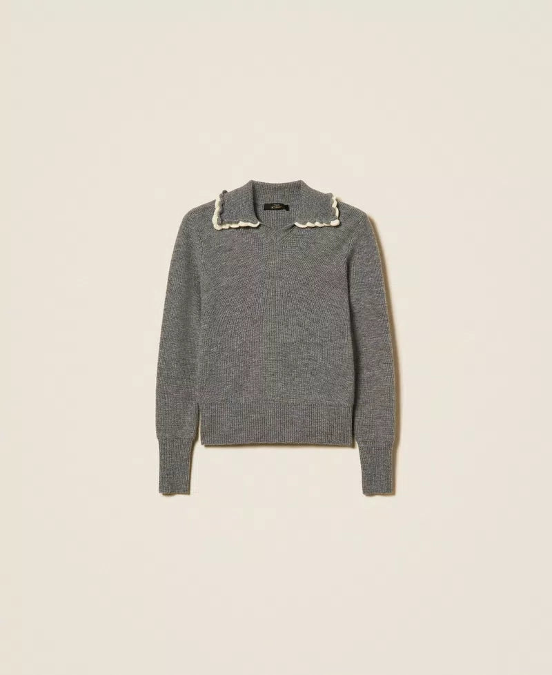A gray knit sweater with a pointed collar trimmed in white lace, displayed flat against a light beige background.
