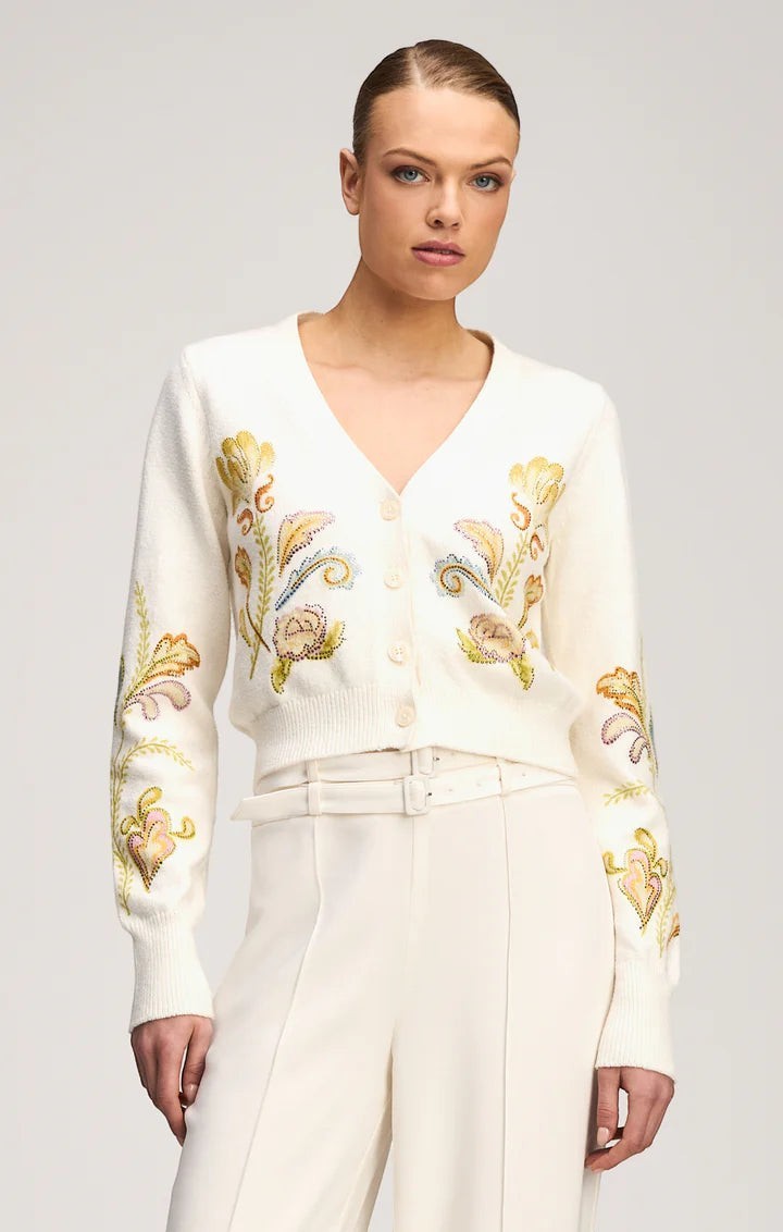 Model wearing a Coats and co. cream V-neck button-down cardigan with intricate multi-colored floral embroidery.