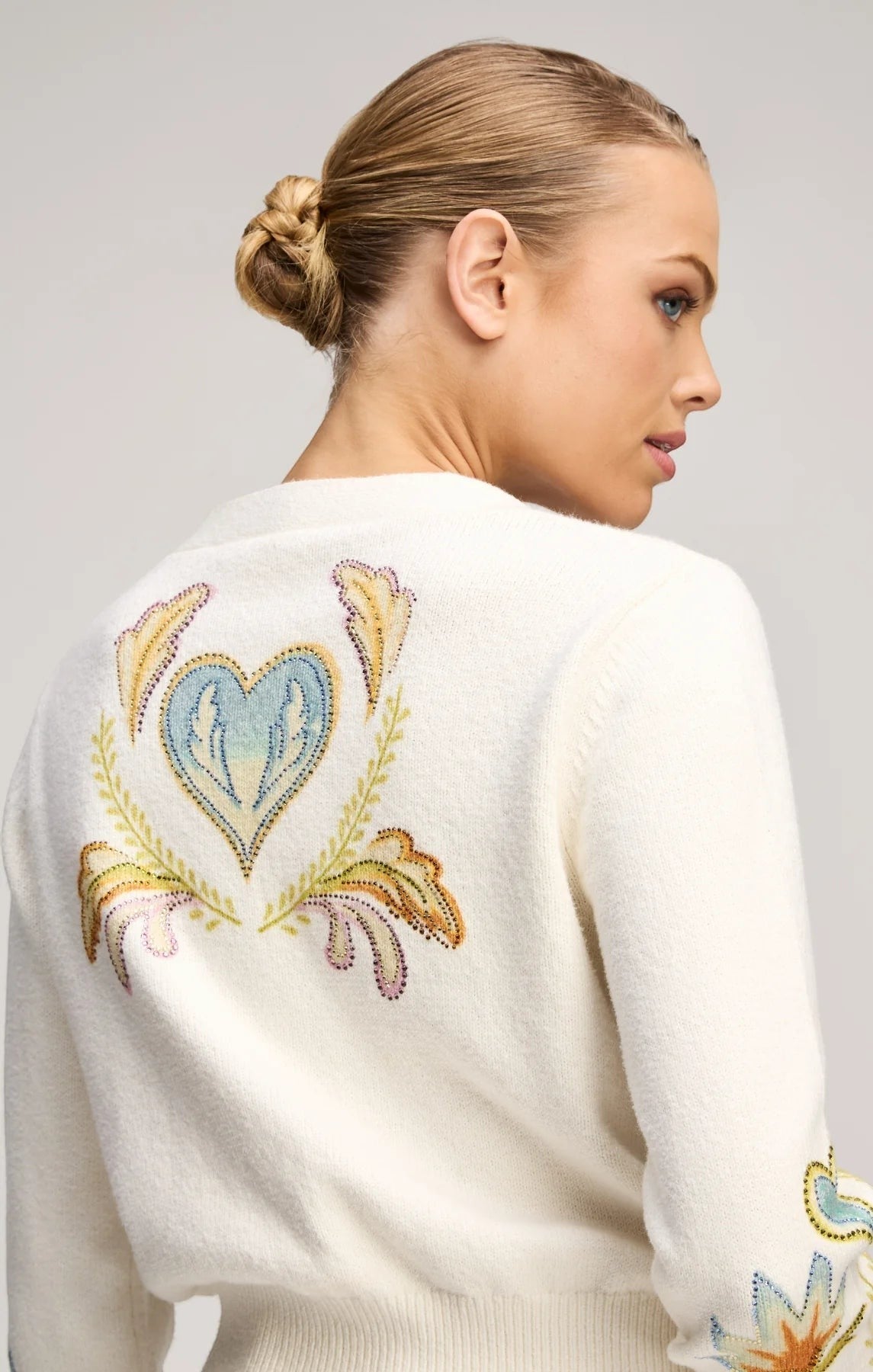 Coats and co. cream knit cardigan featuring intricate multi-colored heart and floral embroidery on the back