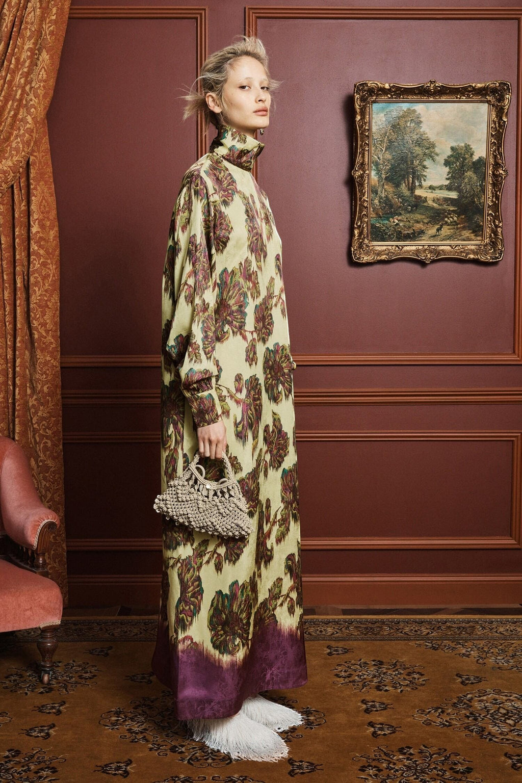 Model wearing a Coats and co. yellow and purple floral print maxi dress with a high neck and long sleeves.