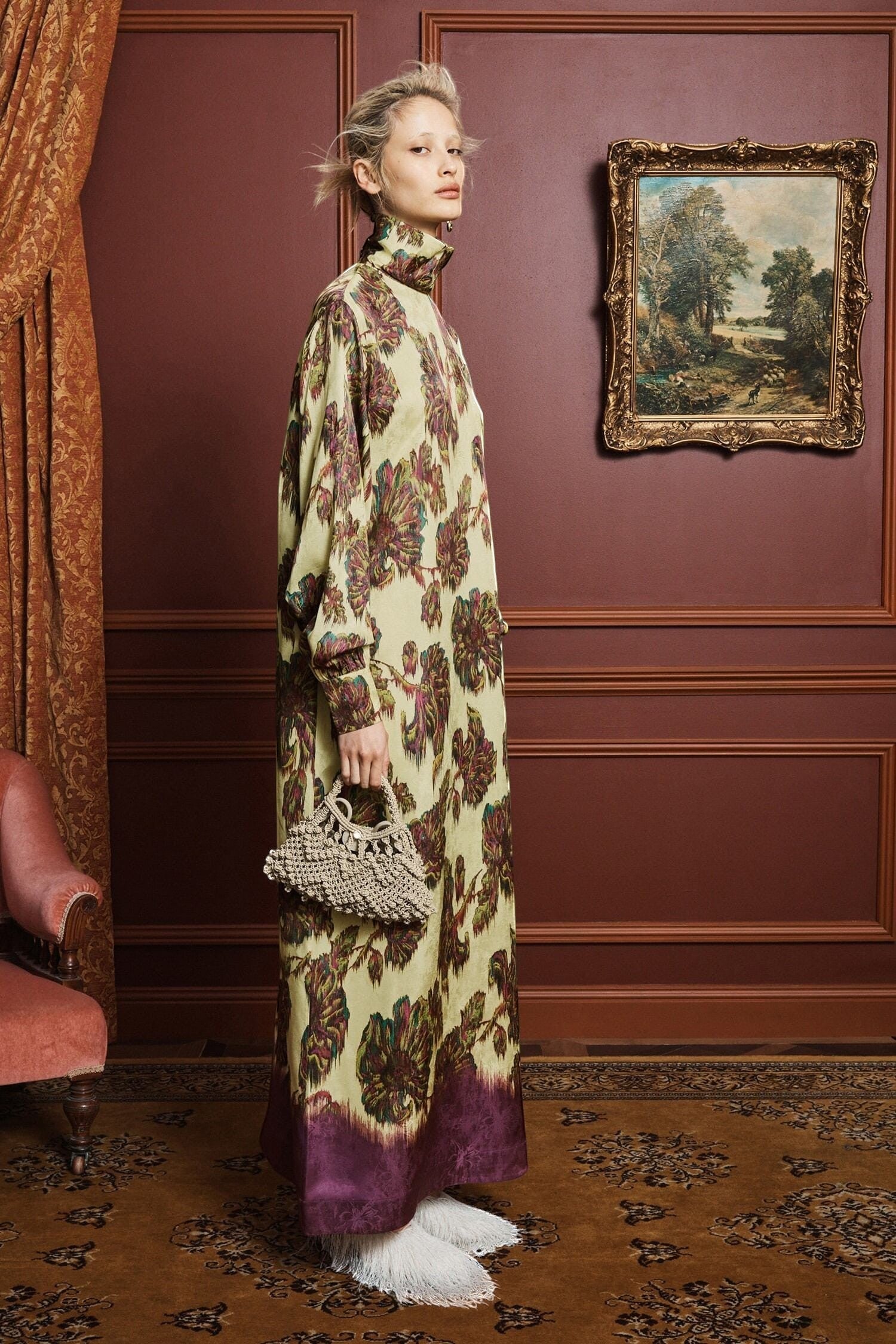 Model wearing a Coats and co. yellow and purple floral print maxi dress with a high neck and long sleeves.